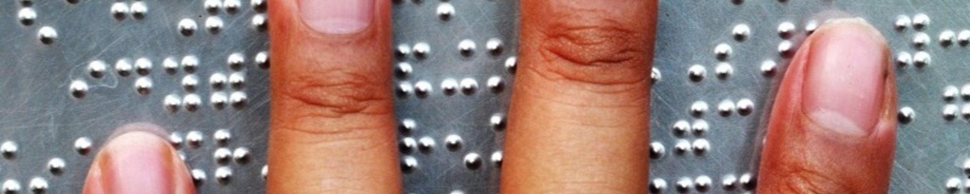 Close up of user's hand on braille