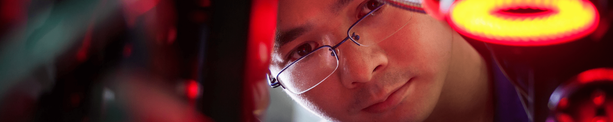 Man employed as welder looking intently at object