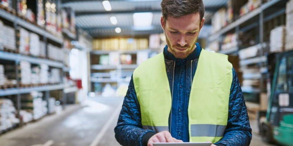 Man in warehouse with clipboard