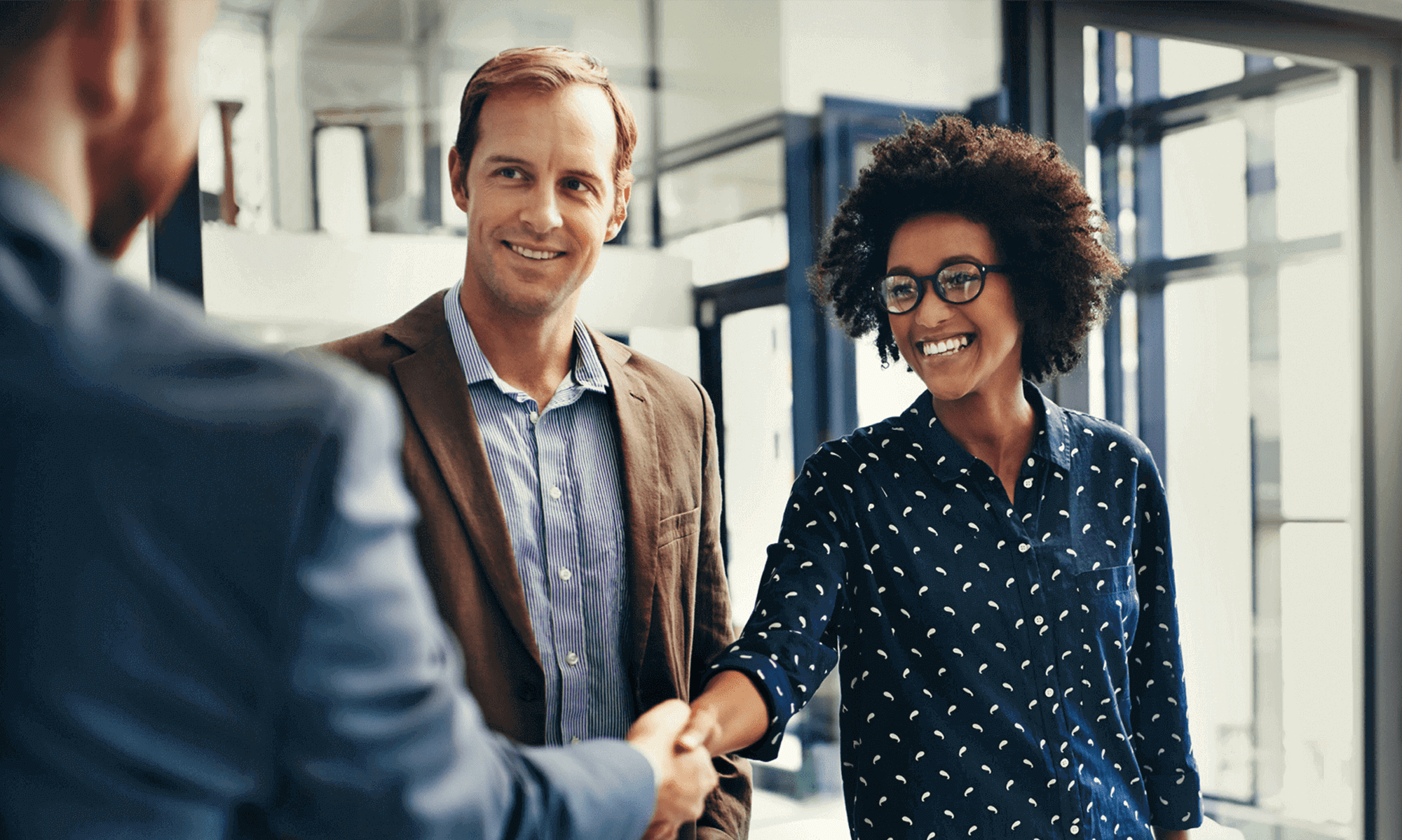 Woman shaking hands with man