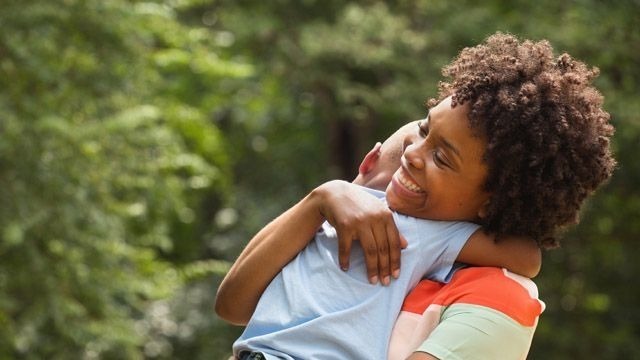 Social worker hugging young boy