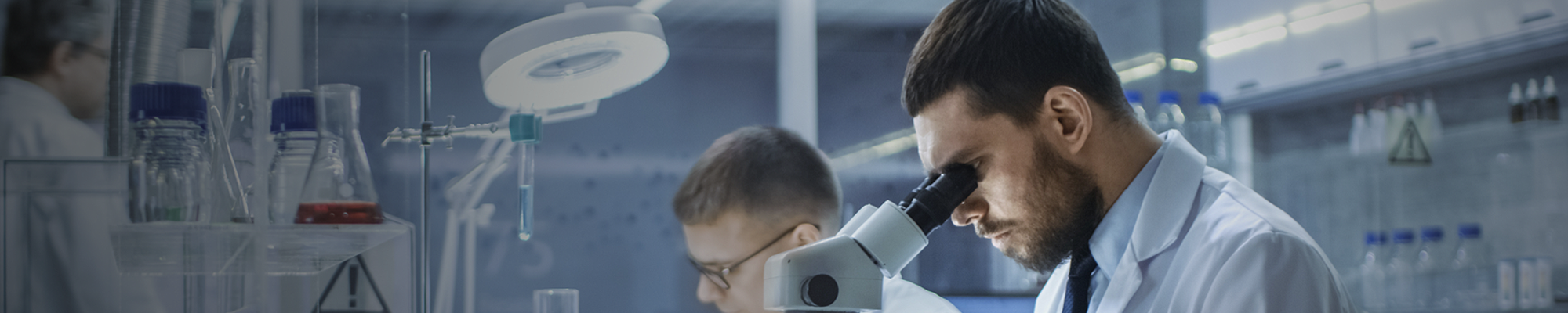 Lab technician working with microscope